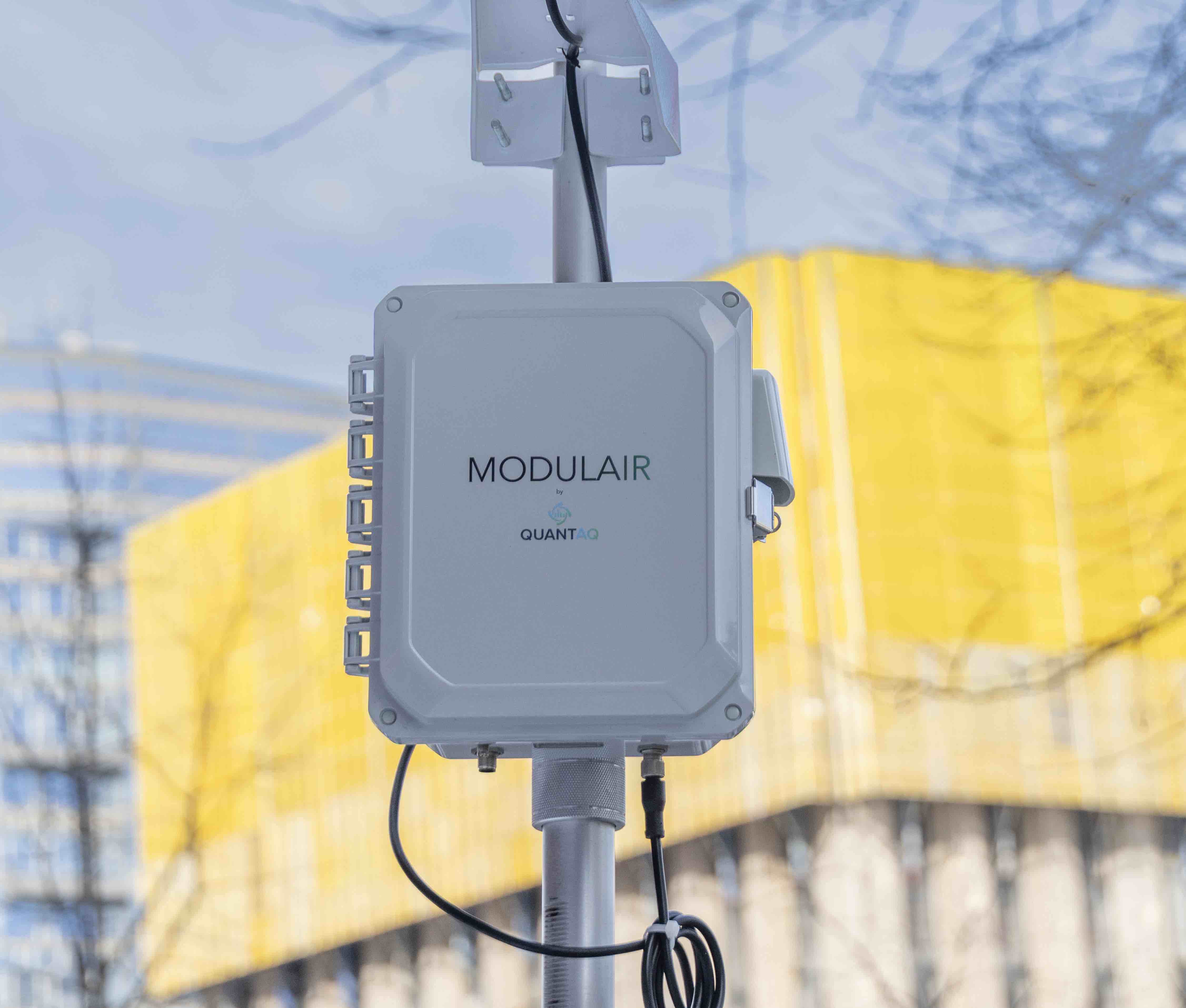 MODULAIR device on a pole with a weather station attached in front of a building